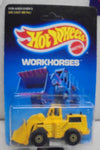 1986 HOT WHEELS WORKHORSES YELLOW CAT WHEEL LOADER UNPUNCHED CARD