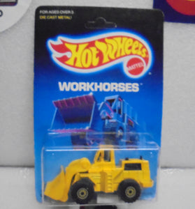 1986 HOT WHEELS WORKHORSES YELLOW CAT WHEEL LOADER UNPUNCHED CARD